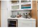 Modern wet bar with white cabinets and wine cooler at 1534 Wexford N Dr, Palm Harbor, FL 34683