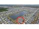 Wide aerial view of the community, highlighting the subject house near a lake at 16779 Sunburst Lake St, Wimauma, FL 33598