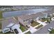 Aerial view showcasing the house's location near a lake and other homes at 16779 Sunburst Lake St, Wimauma, FL 33598