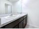 Clean bathroom with double vanity and granite countertop at 16779 Sunburst Lake St, Wimauma, FL 33598