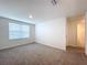 Spacious bedroom with large window and access to bathroom at 16779 Sunburst Lake St, Wimauma, FL 33598