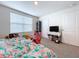 Cozy bedroom with TV, window, and plenty of space at 16779 Sunburst Lake St, Wimauma, FL 33598