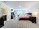 Spacious bedroom with carpeted floors and en-suite bathroom at 16779 Sunburst Lake St, Wimauma, FL 33598
