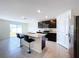 Modern kitchen with island, stainless steel appliances, and granite countertops at 16779 Sunburst Lake St, Wimauma, FL 33598