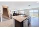 Open concept kitchen with island and view of living room and stairs at 16779 Sunburst Lake St, Wimauma, FL 33598