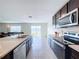 Bright kitchen with stainless steel appliances and view of backyard at 16779 Sunburst Lake St, Wimauma, FL 33598