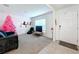Living room with pink Christmas tree, comfortable seating, and a large TV at 16779 Sunburst Lake St, Wimauma, FL 33598