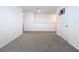 Bright loft area with neutral carpet and a door at 16779 Sunburst Lake St, Wimauma, FL 33598