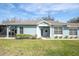 Light blue house with a short walkway to the front door and a grassy lawn at 19208 Weymouth Dr, Land O Lakes, FL 34638