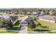 Aerial view of a single-Gathering home with a landscaped yard and a lake in the background at 19724 Post Island Loop, Land O Lakes, FL 34638