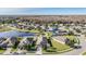 Aerial view of community with lake and homes at 19724 Post Island Loop, Land O Lakes, FL 34638