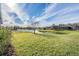 Spacious backyard with pond view and fenced-in area at 19724 Post Island Loop, Land O Lakes, FL 34638