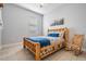 Comfortable bedroom with wooden bed frame and rocking chair at 19724 Post Island Loop, Land O Lakes, FL 34638