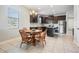 Kitchen dining area with wooden table and four chairs at 19724 Post Island Loop, Land O Lakes, FL 34638