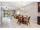 Small dining area with wooden table and chairs, open to living room at 19724 Post Island Loop, Land O Lakes, FL 34638