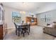 Combined dining and living room with wooden furniture and carpet at 19724 Post Island Loop, Land O Lakes, FL 34638