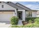 House entrance with gray siding, landscaping, and a walkway at 19724 Post Island Loop, Land O Lakes, FL 34638