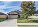 One-story house with garage and landscaping at 19724 Post Island Loop, Land O Lakes, FL 34638