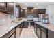 Modern kitchen with dark wood cabinets and granite countertops at 19724 Post Island Loop, Land O Lakes, FL 34638