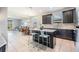 Modern kitchen with dark cabinets, granite countertops and island at 19724 Post Island Loop, Land O Lakes, FL 34638