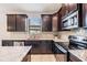 Dark wood cabinets, granite countertops, and stainless steel appliances at 19724 Post Island Loop, Land O Lakes, FL 34638