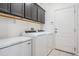 Laundry room with washer, dryer, and storage cabinets at 19724 Post Island Loop, Land O Lakes, FL 34638