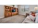 Relaxing living room with a large wooden shelving unit at 19724 Post Island Loop, Land O Lakes, FL 34638