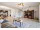Spacious living room with large TV and access to kitchen and bedroom at 19724 Post Island Loop, Land O Lakes, FL 34638