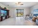 Living room with comfortable seating and access to backyard patio at 19724 Post Island Loop, Land O Lakes, FL 34638