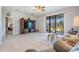 Living area with comfortable seating, TV, and sliding doors to patio at 19724 Post Island Loop, Land O Lakes, FL 34638