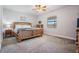 Spacious main bedroom with a large wooden bed frame at 19724 Post Island Loop, Land O Lakes, FL 34638