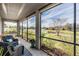 Spacious screened porch with lake view and seating at 19724 Post Island Loop, Land O Lakes, FL 34638