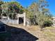 Unkempt backyard with block structure and some trees at 2105 W Gray St, Tampa, FL 33606