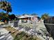Brick duplex with fenced yard, off-street parking, and bike at 2105 W Gray St, Tampa, FL 33606