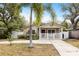 Charming home with a well-manicured lawn, palm tree, and a white picket fence surrounding the front porch at 2429 Park N St, St Petersburg, FL 33710