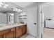 Double vanity bathroom with wood cabinets and tiled floor at 26614 Castleview Way, Wesley Chapel, FL 33544