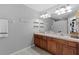 Double vanity bathroom with wood cabinets and tiled floor at 26614 Castleview Way, Wesley Chapel, FL 33544