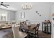 Dining area with table and chairs, and adjacent living area at 26614 Castleview Way, Wesley Chapel, FL 33544