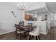 Dining area with kitchen view, wooden table and chairs at 26614 Castleview Way, Wesley Chapel, FL 33544