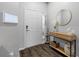 Modern entryway with console table and keyless entry at 26614 Castleview Way, Wesley Chapel, FL 33544