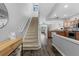 Bright entryway with stairs leading to upper level and view into kitchen at 26614 Castleview Way, Wesley Chapel, FL 33544