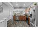 Open kitchen with stainless steel appliances and granite countertops at 26614 Castleview Way, Wesley Chapel, FL 33544