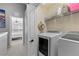Laundry room with washer, dryer, and shelving at 26614 Castleview Way, Wesley Chapel, FL 33544