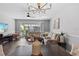 Living room with sectional sofa and fireplace, access to patio at 26614 Castleview Way, Wesley Chapel, FL 33544