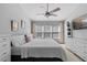 Spacious primary bedroom with large windows, ceiling fan and ample closet space at 26614 Castleview Way, Wesley Chapel, FL 33544