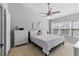 Spacious primary bedroom with large windows, ceiling fan and ample closet space at 26614 Castleview Way, Wesley Chapel, FL 33544