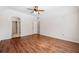 Large bedroom with wood-look floors and access to bathroom at 301 Cordova Grn, Seminole, FL 33777