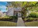 Two-story condo building with landscaped grounds and walkway at 301 Cordova Grn, Seminole, FL 33777