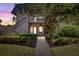 Unit exterior at sunset with walkway and landscaping at 301 Cordova Grn, Seminole, FL 33777