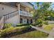 Condo building with stairs, balcony, and landscaping at 301 Cordova Grn, Seminole, FL 33777